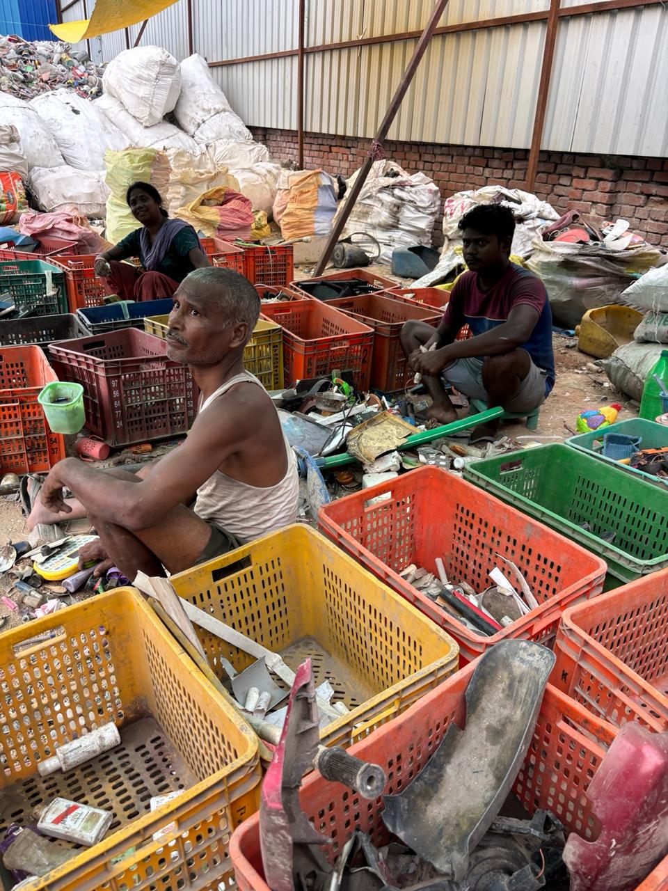 Waste workers sorting materials at a community recovery site